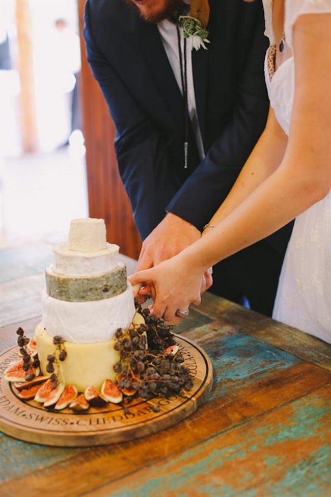 Cutting a cheese wedding cake