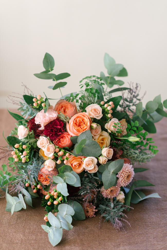 An Organic Hand-Tied Bridal Bouquet in Blush, Peach & Marsala