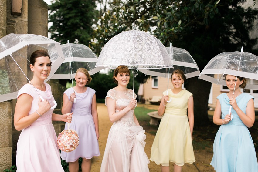 Bride & Bridesmaids under umbrellas