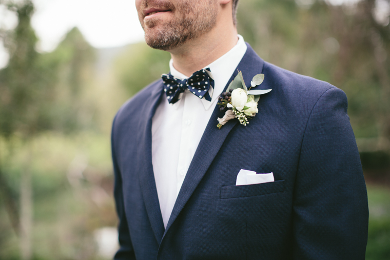 Groom wearing a Blue Suit & Polka Dot Bow Tie // Photography - White Images
