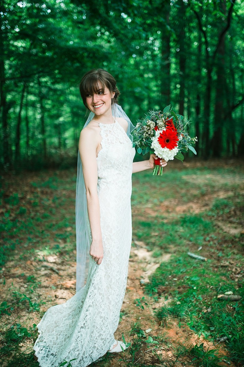 Bride in a Lace Dress with Red Bridal Bouquet