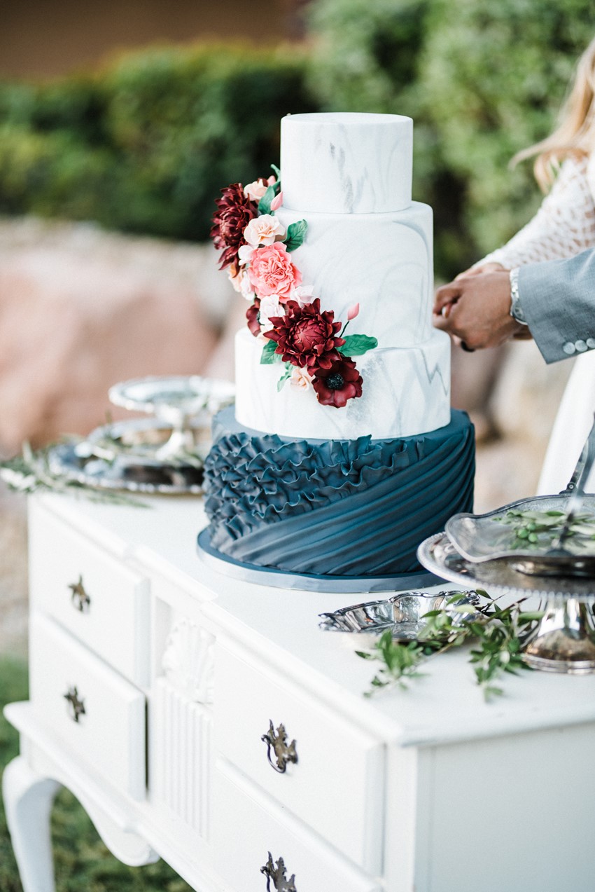 Bride & Groom Cutting a Floral & Ruffled Wedding Cake