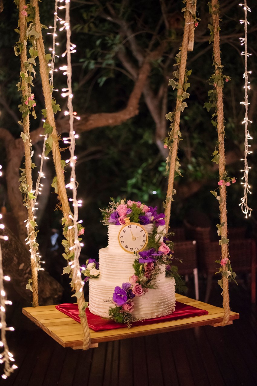 Floral Topped Wedding Cake on a Swing