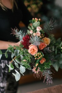 An Organic Hand-Tied Bridal Bouquet of Roses in Blush, Peach & Marsala