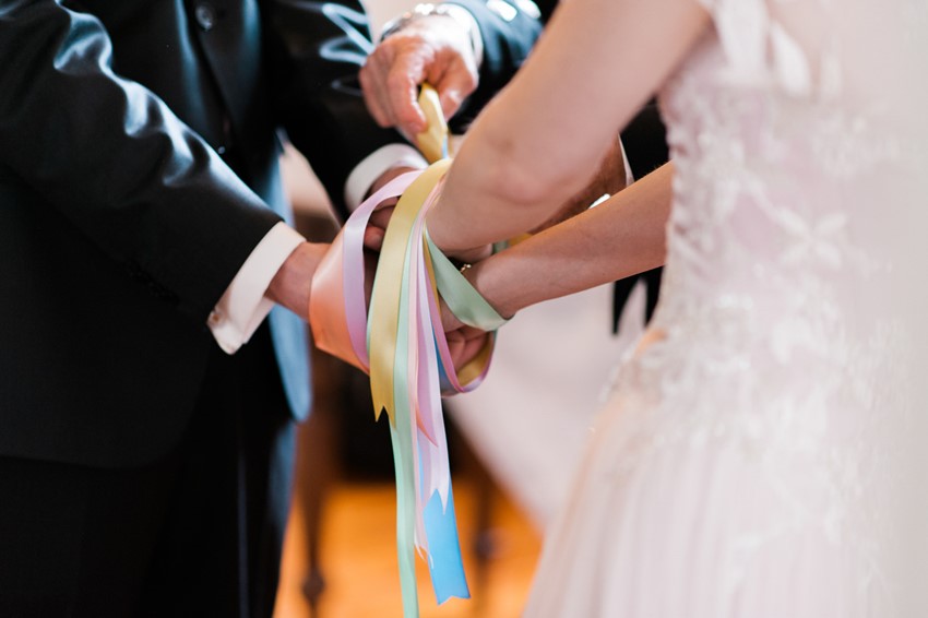 Handfasting ritual in pastel ribbons