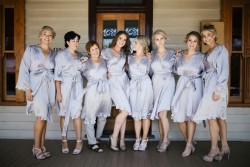 Bride & bridesmaids in satin robes // Photography by Brown Paper Parcel