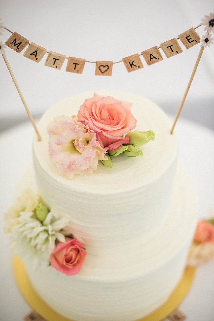 White Wedding Cake with bunting wedding cake topper // Photography ~ Meredith Lord Photography