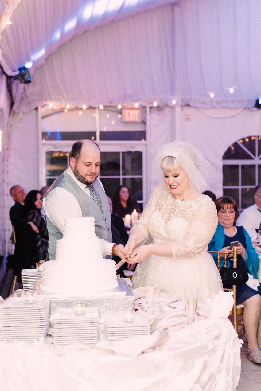 Vintage bride & groom cutting the cake