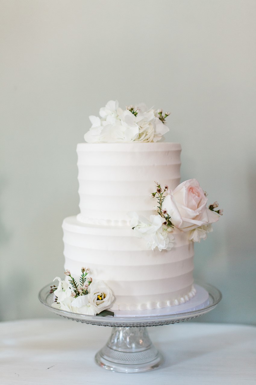 White Wedding Cake topped with Roses